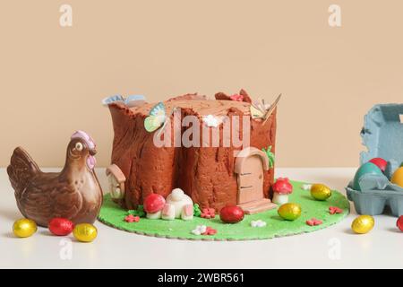 Easter log cake with textured look on the tree trunk and Easter bunny Stock Photo