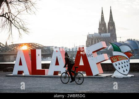 two-meter-high Alaaf lettering stands in the district Deutz, in the background the cathedral. Gift from the Festkomitee Koelner Karneval for the 200th Stock Photo