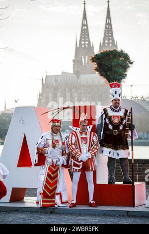 the triumvirate of the carnival society Altgemeinde Rodenkirchen stands in front of the two-meter-high Alaaf lettering in the district Deutz, in the b Stock Photo