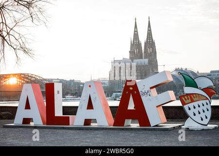 two-meter-high Alaaf lettering stands in the district Deutz, in the background the cathedral. Gift from the Festkomitee Koelner Karneval for the 200th Stock Photo