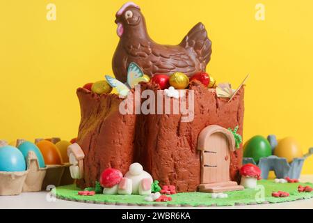 Easter log cake with textured look on the tree trunk and Easter bunny Stock Photo