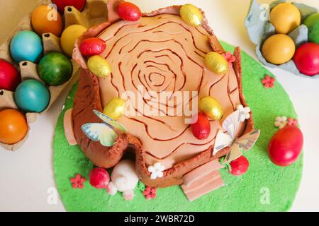 Easter log cake with textured look on the tree trunk and Easter bunny Stock Photo