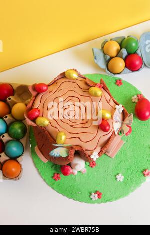Easter log cake with textured look on the tree trunk and Easter bunny Stock Photo