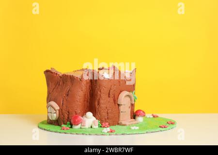 Easter log cake with textured look on the tree trunk and Easter bunny Stock Photo