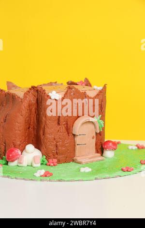 Easter log cake with textured look on the tree trunk and Easter bunny Stock Photo