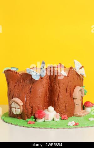 Easter log cake with textured look on the tree trunk and Easter bunny Stock Photo