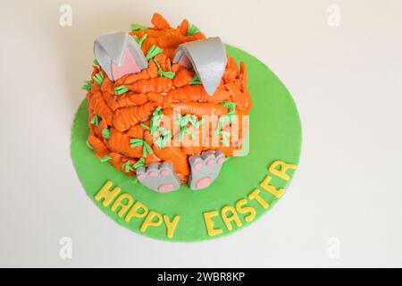 Carrot covered Easter bunny cake, happy Easter concept Stock Photo