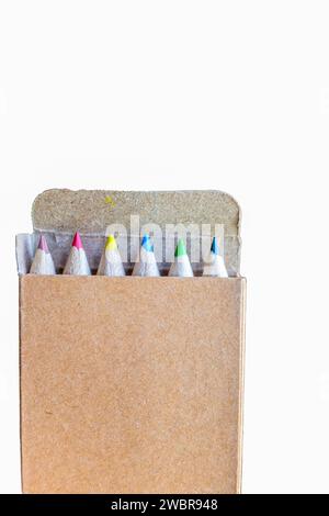 five colored pencils in a carton box on a white background Stock Photo