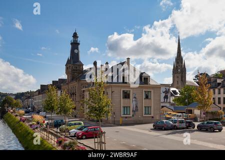 Châteaulin, France - August 29 2021: Parish church of Saint-Idunet, the post office, the town hall and the Aulne river. Stock Photo