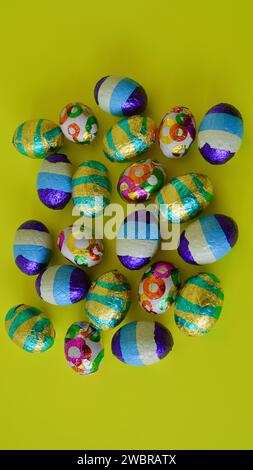 A closeup of colorful chocolate Easter eggs on the table. Stock Photo