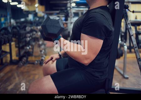 Close-up of a concentrated man doing strength exercises in a gym Stock Photo