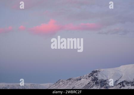 Snowy mountain ridge under cloudy sky Stock Photo