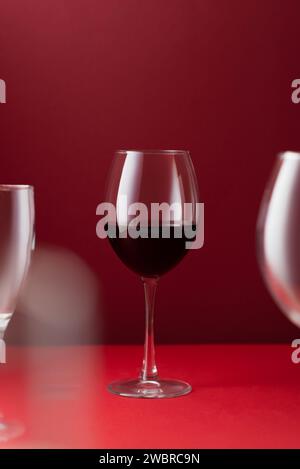 Glass of red wine on a red background art photography Stock Photo