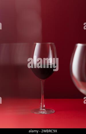 Glass of red wine on a red background art photography Stock Photo