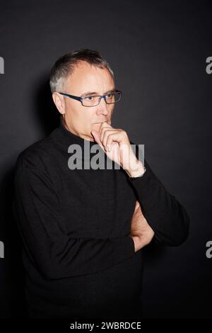 Senior man, thinking and ideas with decision, choice and confident guy on a dark studio background. Mature person, mockup space and model with glasses Stock Photo