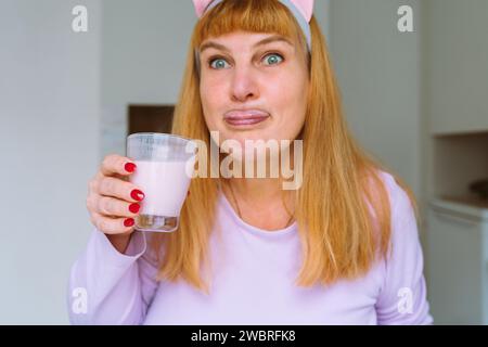 Middle aged woman drinking yogurt Stock Photo