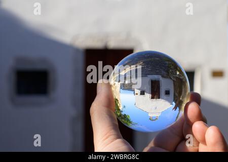 A small church near Pernat in Cres seen through lens ball, sunny day in autumn, blue sky Stock Photo