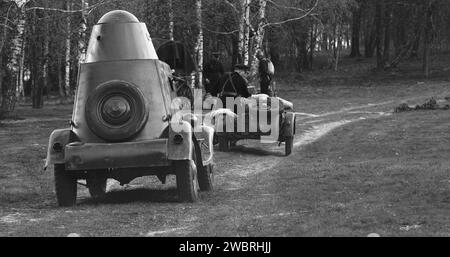 Soviet Russian Armored Combat Vehicle And Soviet Troops On Motorcycles With Sidecars. Soviet World War Ii Automotive. Black And White Stock Photo