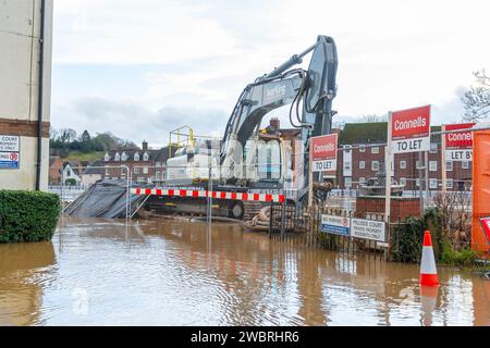 Bewdley, UK. 3rd January, 2024. UK weather: After many days of rainfall, flood waters hit close to record levels in Bewdley. Machine equipment stands in flood water where the new permanent flood barriers are to be erected in the future. Credit: Lee Hudson/Alamy Live News Stock Photo