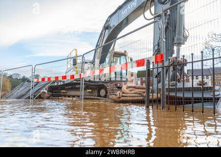 Bewdley, UK. 3rd January, 2024. UK weather: After many days of rainfall, flood waters hit close to record levels in Bewdley. Machine equipment stands in flood water where the new permanent flood barriers are to be erected in the future. Credit: Lee Hudson/Alamy Stock Photo