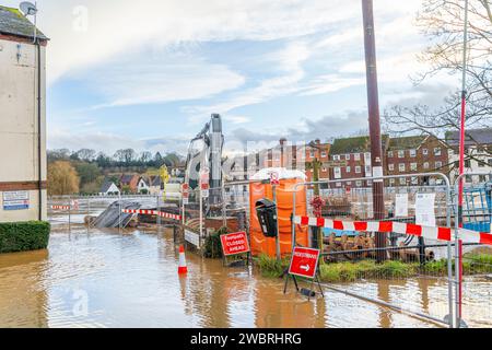 Bewdley, UK. 3rd January, 2024. UK weather: After many days of rainfall, flood waters hit close to record levels in Bewdley. Machine equipment stands in flood water where the new permanent flood barriers are to be erected in the future. Credit: Lee Hudson/Alamy Stock Photo