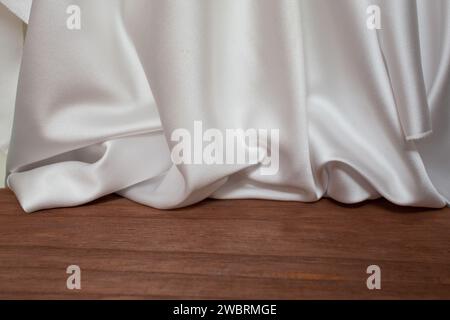 empty wooden floor with Elegant wavy white satin cloth curtains, defocused in the background, product placement  stage Stock Photo