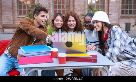 Group of students, prepare for university exams, use a laptop. Stock Photo