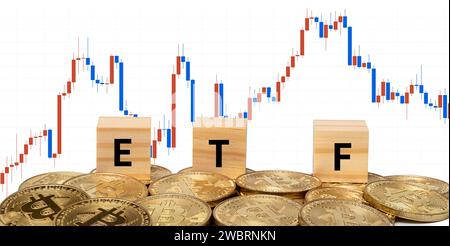 Wood chips and ETF text on top of Bitcoin on chart background Stock Photo
