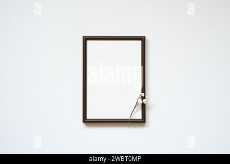 Wooden picture frame with dry branch isolated on white background. copy space Stock Photo