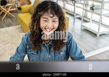 A young Asian graphic designer woman working in a creative dynamic office Stock Photo