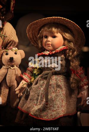 A pretty doll with a nice ditsy dress and straw hat. Stock Photo