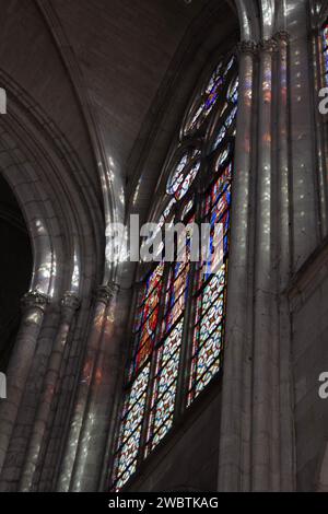 Coloured spots enliven the columns of St Urbain Basilica, Troyes, France, as the sun shines through stained-glass made in 1903 by Édouard Didron. Stock Photo