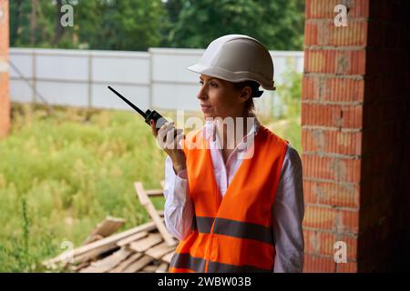 Serious construction manager using radio communication on development site Stock Photo