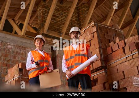 Site supervisor and foreman posing for camera during construction inspection Stock Photo