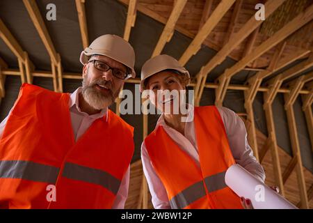 Foreman and construction supervisor posing for camera during house inspection Stock Photo