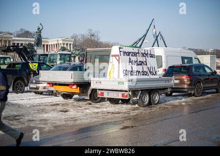 Galgen auf Traktoren. Am 12. Januar 2024 versammelten sich tausende Teilnehmer*innen auf der Theresienwiese in München Deutschland, um gemeinsam mit dem Verband der Transport-und Logistikunternehmen ( BGL Süd ) und Landesverband Bayerischer Transport- und Logistikunternehmen ( LBT ) e.V., um gegen Ampelregierung zu demonstrieren. Der Großteil der Teilnehmer*innen reiste mit dem eigenen Lkw, Traktor, Baufahrzeug oder ähnliches an. So fanden sich über 1800 Fahrzeuge am Versammlungsort ein. Die Demo war Teil der Protestwoche der Bauernproteste. -- Traffic Light coalition parties. hanging from th Stock Photo