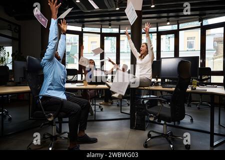 Cheerful colleagues celebrating successful project completion Stock Photo