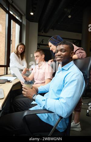 Smiling man manager of developing company looking at camera Stock Photo