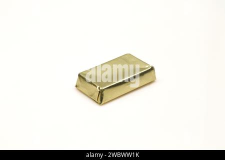 Golden color foil wrapped bite size chocolate mini dessert isolated on white background Stock Photo