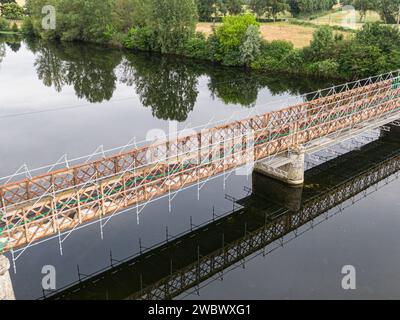 Scaffolding used for maintenance or restoration work on a small bridge over a large river the Cher Stock Photo