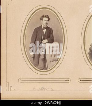 Portrait of a young man with a staff in hand, leaning on the handrail of a chair, Kannemans & Son, 1867 - 1879 Photograph. visit card This photo is part of an album. Breda cardboard. photographic support albumen print historical persons. youth, adolescent. chair. walking-stick, staff Stock Photo