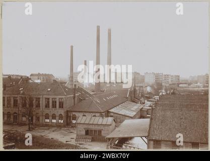 Exterior of factory buildings with chimneys, anonymous, c. 1900 - c. 1910 photograph Part of Family Album with photos of Wijnhandel Kraaij & Co. Bordeaux-Amsterdam.  photographic support  factory-building. smoke-stack Stock Photo