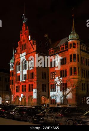 Zurich, Switzerland - 02. January 2022: The new year light show in down town Zurich with Swiss national flag projected on public buildings. Stock Photo