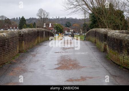 Cookham, UK. 12th January, 2024. The main road across Cookham Moor remains closed due to flooding. The nearby old Causeway (pictured) is being used by residents but on a strictly limited basis due to the narrow road and old bridge. The village of Cookham in Berkshire is slowly beginning to dry out after the River Thames burst its banks last weekend. The river levels are finally dropping. Now the expensive clean up will begin by residents and the Royal Borough of Windsor & Maidenhead. Credit: Maureen McLean/Alamy Stock Photo