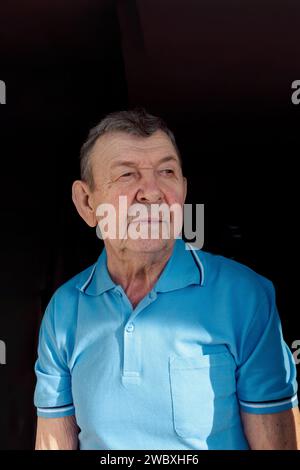 Portrait of elderly man on black background. Thoughtful look of old senior. Close-up of wrinkled face, copy space. High quality photo Stock Photo