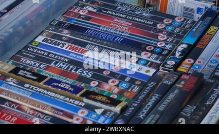 Ross On Wye, Herefordshire, England Sept 24 2023:  A collection of old second hand dvd's for sale in a bric a brac shop. stacked in a box Stock Photo