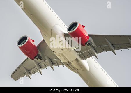 Fuselage of an airline passenger plane taking flight towards its destination on a day with gray skies without masses of clouds Stock Photo