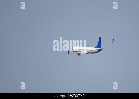a jet cargo plane a few minutes after takeoff turning in the air to head to its destination Stock Photo