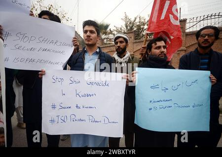 Peshawar, Peshawar, Pakistan. 12th Jan, 2024. Shiite Muslims protest against the death of four people killed including a doctor woman in ParachinarPESHAWAR, PAKISTAN, JANUARY, 12: Pakistani Shiite Muslims, supporters of Imamia Student Organization-ISO, hold a banner and shout slogans during a protest against the sectarian violence inside at Parachinar, in Peshawar, Pakistan, 11 january 2024. A gunman opened fire shots on passenger vehicles near Sada Bazar in Karam district and killed four people including a woman on Sunday. According to the police, the fielder and coach who were going to Pes Stock Photo