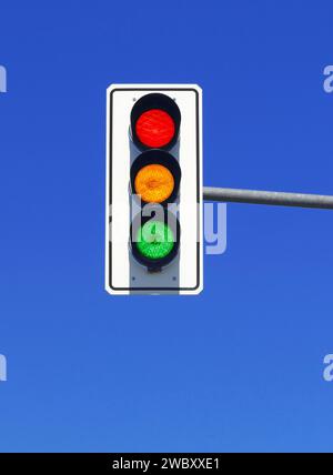 traffic light in blue sky with red, yellow and green lights on Stock Photo